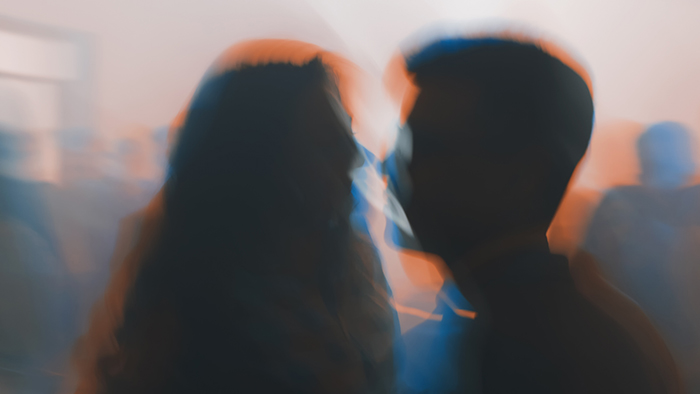 An impressionist style blurred photo of a couple talking