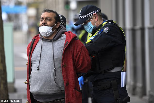 Police have warned anybody attending the rallies will be hit with massive fines (pictured man is detained at an anti-lockdown protest in Melbourne last month)