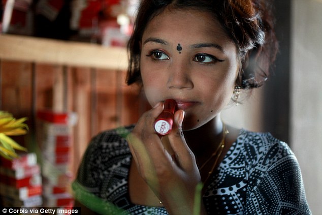 Underage sex worker Bristi applying heavy makeup to appear more mature for her evening clients at Bangladesh
