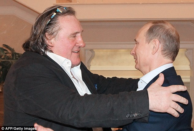 Russian President Vladimir Putin greets French actor Gerard Depardieu during their meeting in Putin