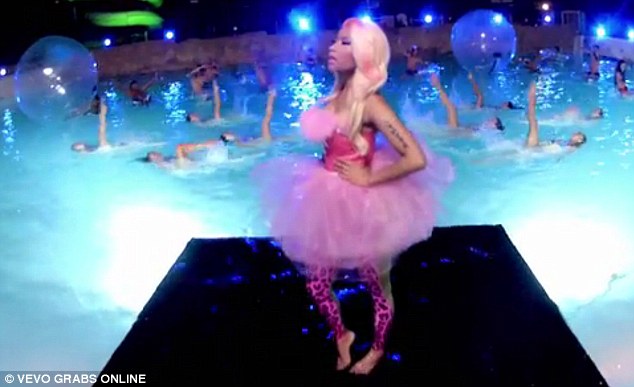Pretty in pink: Songstress Nicki wears a wild outfit consisting of a strapless dress, featuring tutu style skirt paired with leopard print leggings