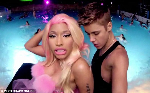 Getting close: Justin is seen flirting and gyrating up to Nicki Minaj in his brand new music video, Beauty And A Beat