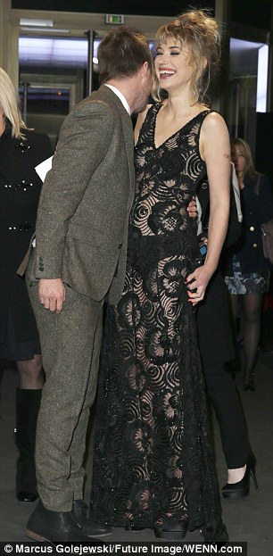 Dressed for success: Aaron Paul leans over to tickle the funny bone of Imogen Poots