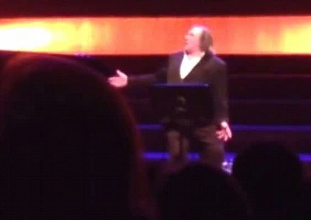Within a few seconds of arriving on stage, Depardieu had ignored much of the prepared text, and was waiving his hands in the air while telling jokes, shouting, and using uncouth language