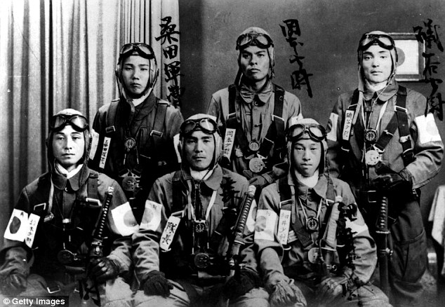 Kamikaze pilots who took part in suicidal missions to try and destroy Allied boats during the Second World War. Pictured in 1942, they have tied honorary ribbons onto their arms before going on their missions