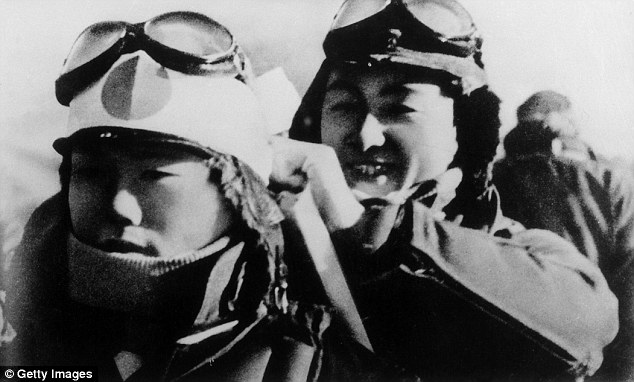 A Japanese kamikaze pilot smiles as he helps another with his gear during World War II. The Mayor of the region covering Chiran said giving the letters special historical protection would not glorify the pilots