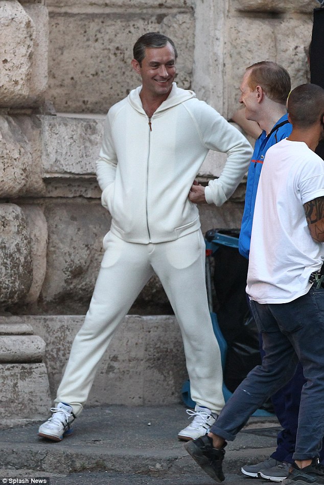 Holy moly: Jude  looked in high spirits as he took a break in between takes, while sporting a casual white tracksuit