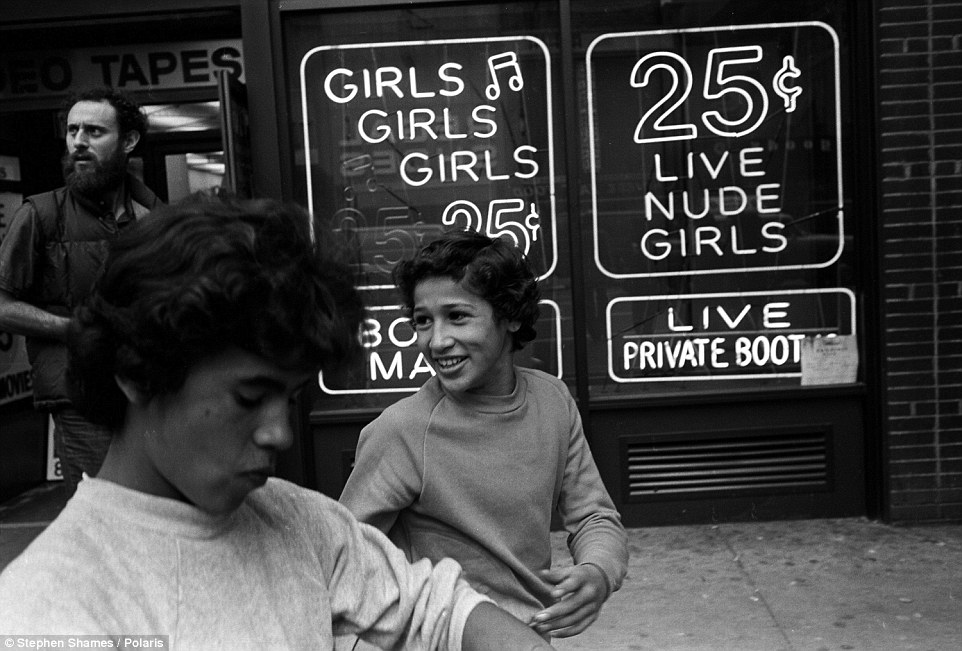 The boys were called street hustlers, which meant that they were drifters who possibly supported their families through prostitution. Two teenage hustlers walk by an x-rated video store in Times Square that offered nude girls for 25 cents