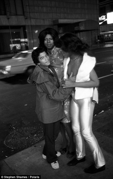 A teenage hustler fooling around with two transvestites