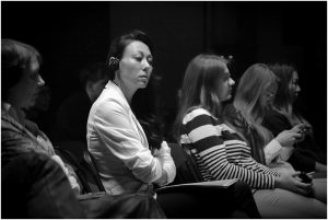 Colleen Montgomery listening to fellow presenters at the at the Aleksei Balabanov Conference in St. Petersburg (thanks for the conference
