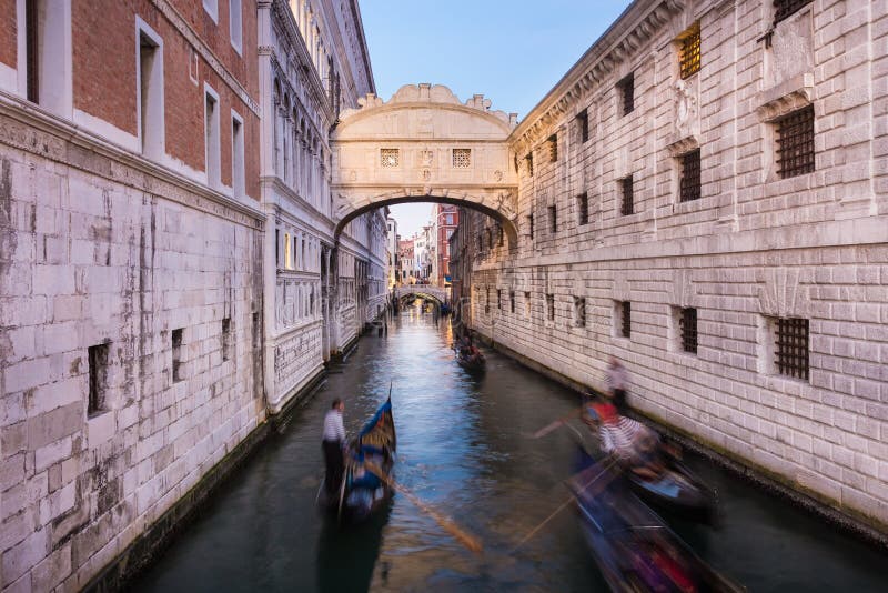 Bridge of Sighs, Venice, Italy. Gondolas passing under Bridge of Sighs, Ponte dei Sospiri. A legend says that lovers will be granted eternal love if they kiss stock photo
