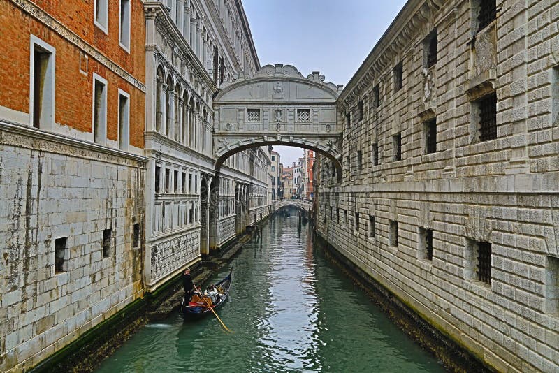 The bridge of sighs in Venice at night, Italy. A tourist gondola sail under famous Bridge of Sighs. It is a landmark of Venice royalty free stock images
