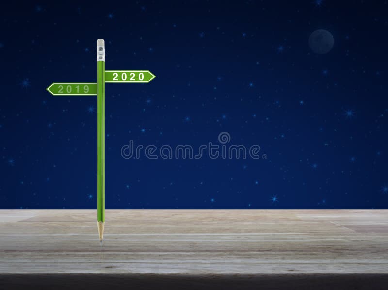 Business happy new year 2020 planning concept. 2020 and 2019 direction sign plate with green pencil on wooden table over fantasy night sky and moon, Business royalty free stock photos