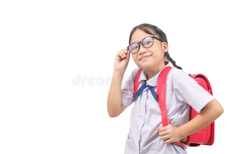 Cute asian girl student wear uniform and carries school bag isolated. Portrait of cute asian girl student wear uniform and carries school bag isolated on white royalty free stock photography