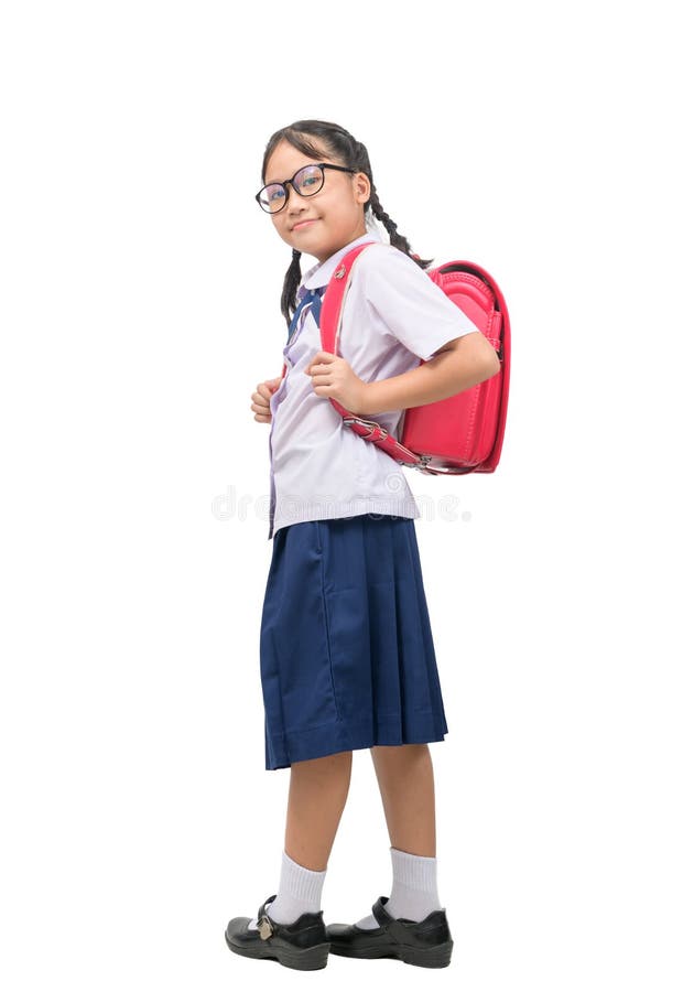 Cute asian girl student wear uniform and carries school bag isolated. Portrait of cute asian girl student  wear uniform and carries school bag isolated on white stock photos