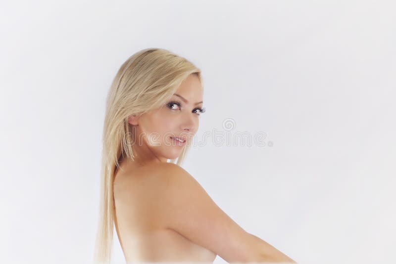 Blondie Headshot - Young and Sexy. A cute blond teen is looking into the camera giving the observer a little sexy smile royalty free stock photos