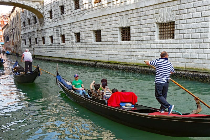Gondolas on the Rio di Palazzo, Under the Bridge of Sighs, Venice, Italy. Traditional gondolas punted along the Rio di Palazzo canal, passing under the Bridge of royalty free stock images