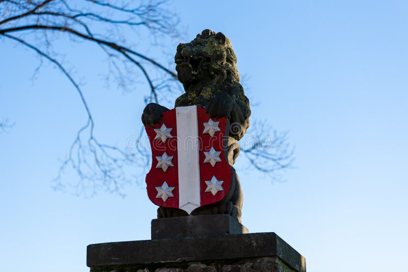 Gouda, South Holland/the Netherlands - January 20 2019: portrait shot of the lion statue with Gouda city logo on the shield stock photo
