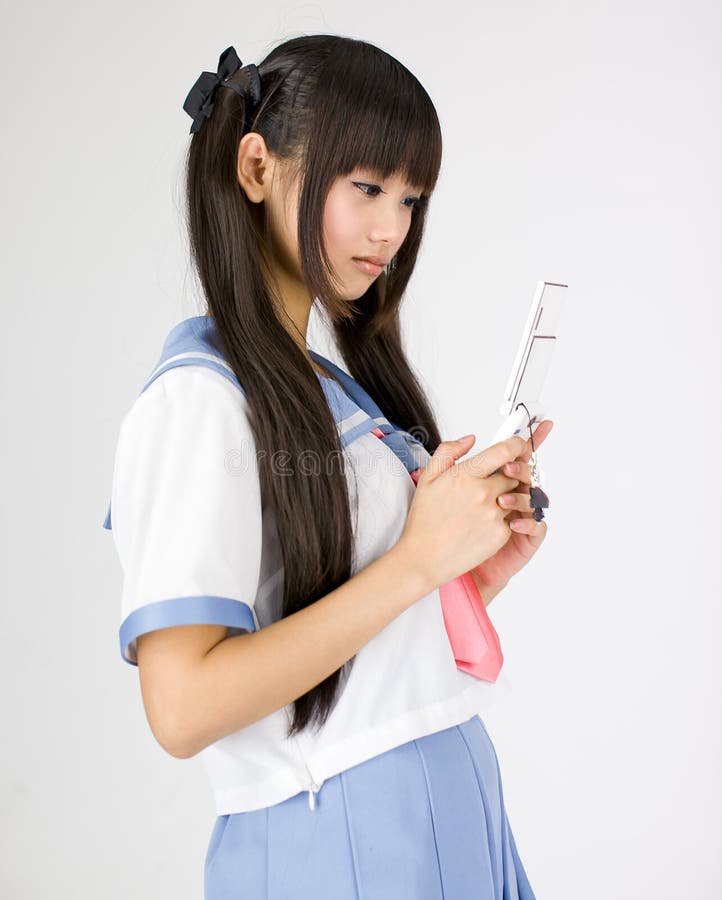 Japanese cute teen school girl. Its a asia/japanese cute teen school girl in pink background stock image