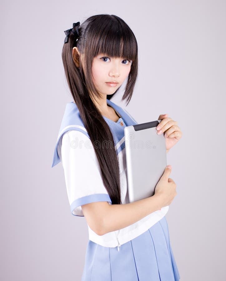 Japanese cute teen school girl. Its a asia/japanese cute teen school girl in pink background stock images