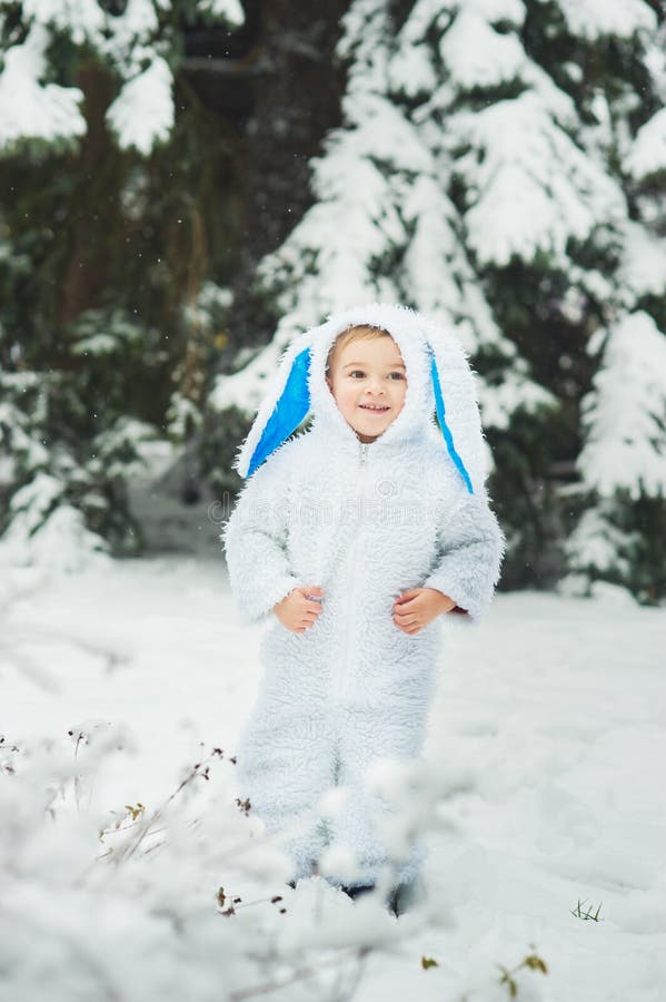A little boy dressed as rabbit meets new year. Portraita little boy dressed as rabbit in winter forest. Child with christmas wreath. Snowy park. character xmas royalty free stock photo