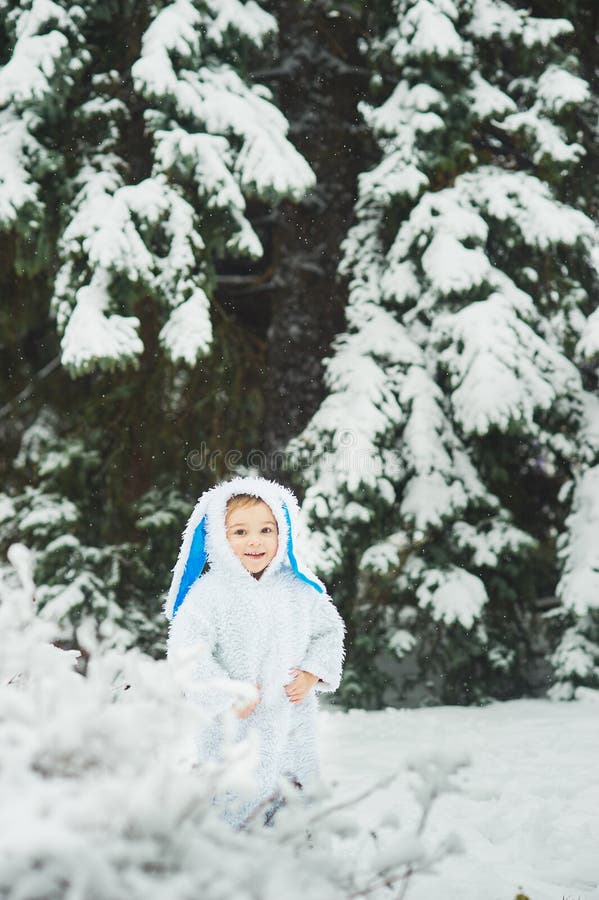 A little boy dressed as rabbit meets new year. Portraita little boy dressed as rabbit in winter forest. Child with christmas wreath. Snowy park. character xmas royalty free stock photography