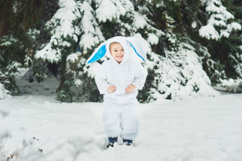 A little boy dressed as rabbit meets new year. Portraita little boy dressed as rabbit in winter forest. Child with christmas wreath. Snowy park. character xmas stock image