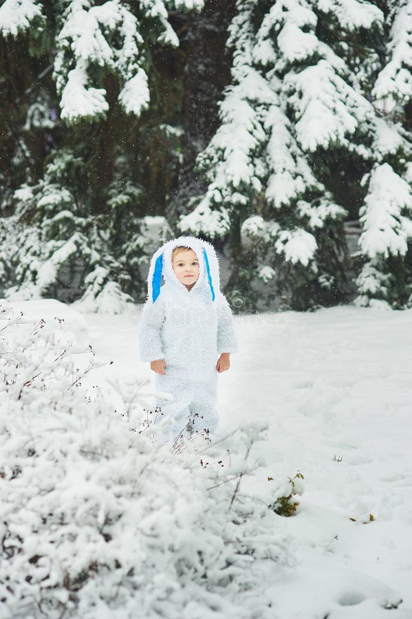 A little boy dressed as rabbit meets new year. Portraita little boy dressed as rabbit in winter forest. Snowy park. character child xmas merry kid childhood stock photography