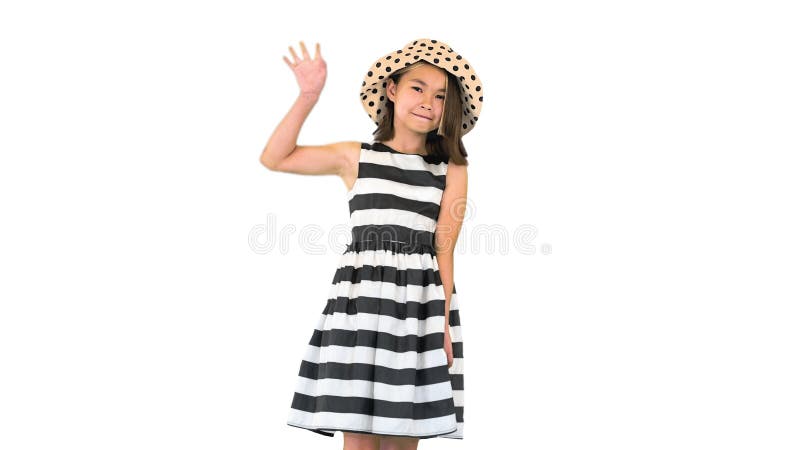 Friendly cute cheerful asian school girl waving hi to the camera. Medium shot. Walking in and out of the frame. Friendly cute cheerful asian school girl waving stock photos