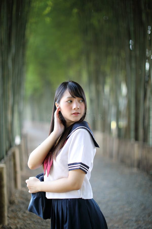 Portrait of beautiful Asian japanese high school girl uniform looking with bamboo forest background. Portrait of beautiful Asian japanese high school girl stock image