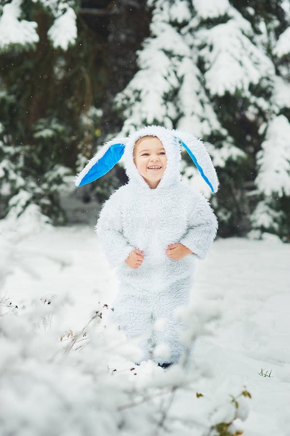 A little boy dressed as rabbit meets new year. Portraita little boy dressed as rabbit in winter forest. Child with christmas wreath. Snowy park. character xmas stock photography