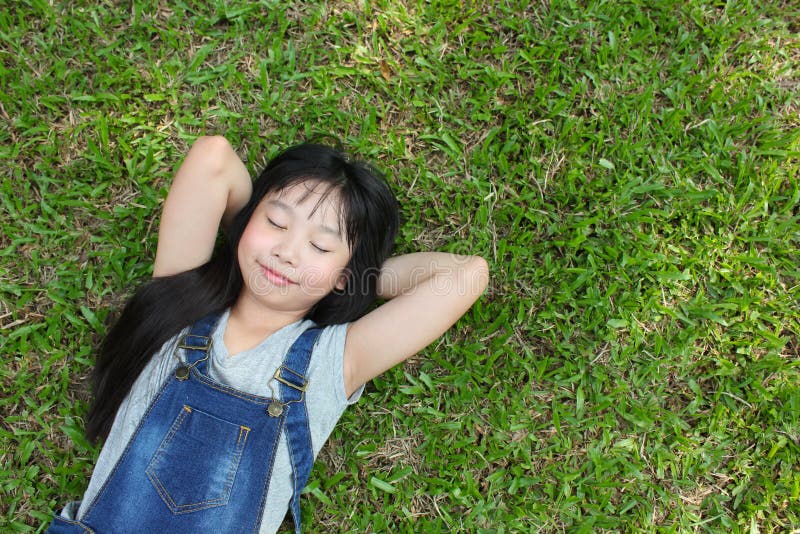 Relaxing in the park. Relaxing in the park, little girl having good time in the park stock photo