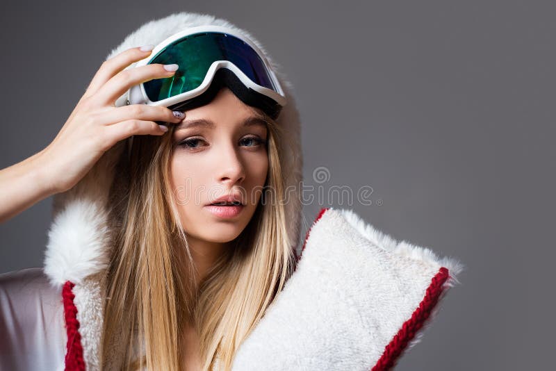 Sexy woman in winter clothes. Portrait of cool young girl in protective helmet and ski mask. Winter time. Attractive. Athletic woman in ski mask. Leisure stock photo