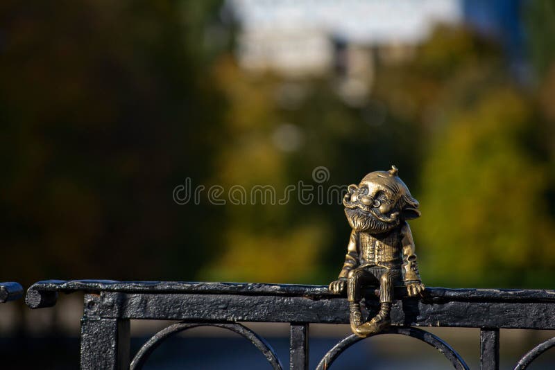 Statuette of the homlin grandfather. Bronze miniature sculpture of the grandfather homlin on the honey bridge royalty free stock photo